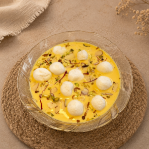 Fresh Angoori Basundi Ahmedabad with mini rasgullas in rich saffron basundi, topped with pistachios, almonds, and saffron strands