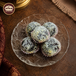 Fresh Kala Jamun Ahmedabad coated with coconut flakes, rich khoya sweet with deep caramel flavour, freshly prepared daily
