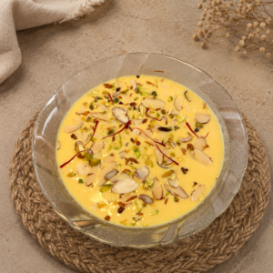 Fresh Kesar Pista Basundi Ahmedabad garnished with saffron, pistachios, almonds, and rich creamy milk, freshly prepared daily