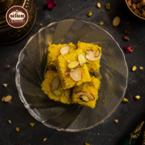 Premium Kesar Barfi Ahmedabad garnished with sliced almonds and pistachios, handcrafted using pure saffron, rich milk, and traditional recipes