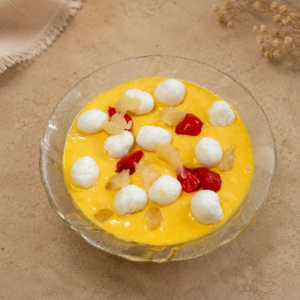 Fresh Mango Delight Cream Salad Ahmedabad with mango cream, mini rasgullas, mixed fruits, and cherries, freshly prepared daily